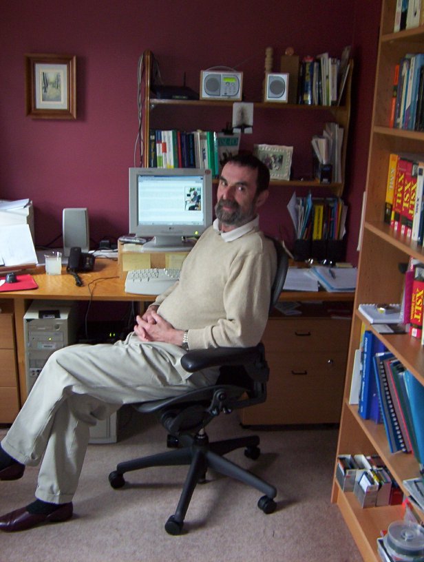Photo of DaveP, in front of the computer, at home